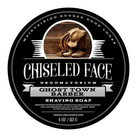 Product image of Chiseled Face Groomatorium's 'Ghost Town Barbershop' shaving soap, featuring a label with cowboy boots, a lasso rope, and leather gloves symbolizing the unique scent.